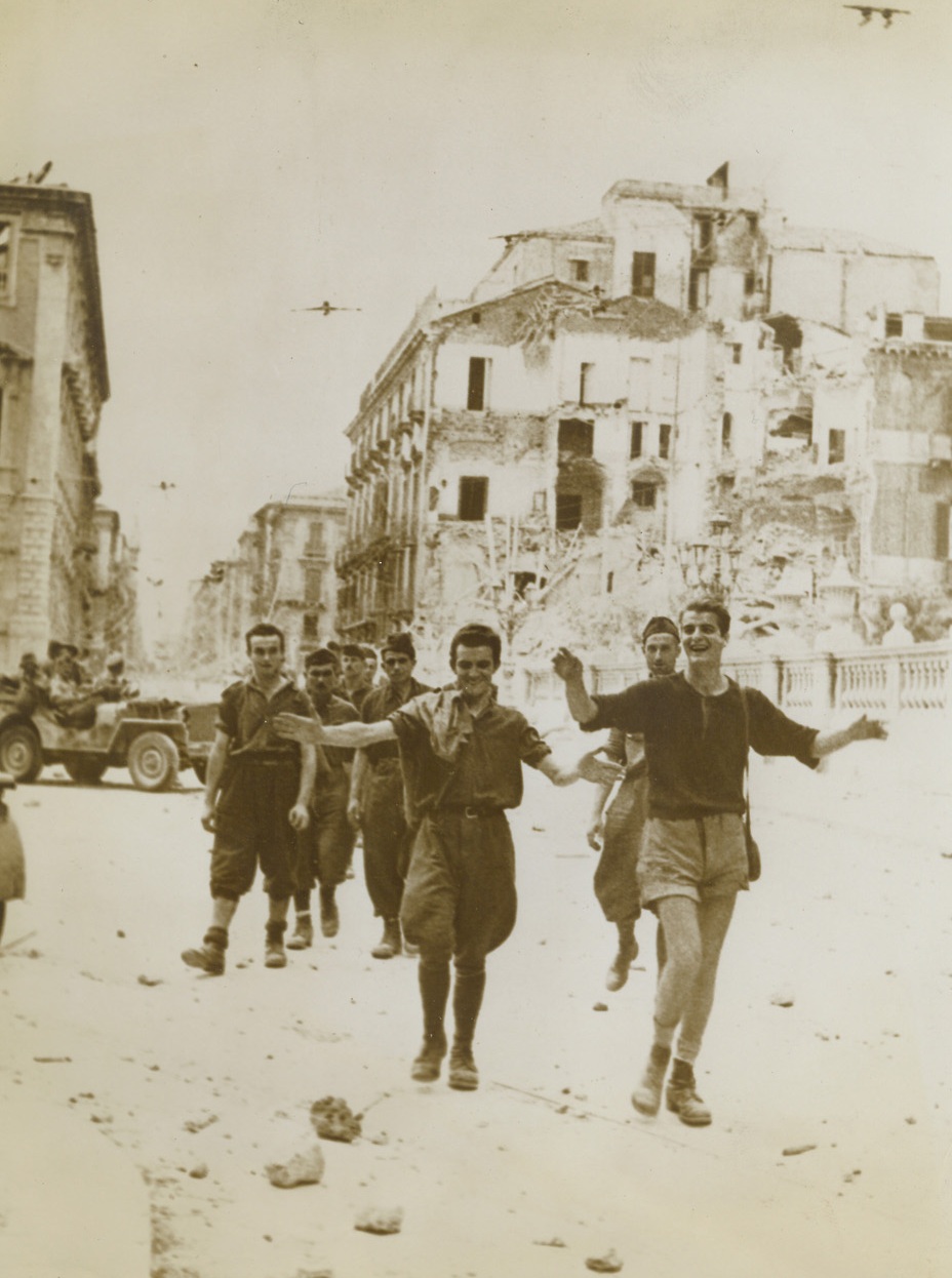 No Title, 8/29/1943. …Troops after the fall of …In the background, a group of Tommies halt their car to watch the unique …of the prisoners march. Credit Line (ACME);