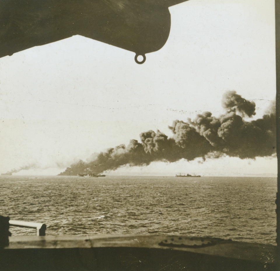 Axis Scores Hit on Sicily Invasion Vessel, 8/31/1943. SICILY—A photo, long delayed by censorship, shows a burning United Nations vessel that was hit by an enemy bomb during the invasion of Sicily. Other ships are unharmed by Axis aircraft that futilely attempted to break up the invasion. Figures have shown our losses to be relatively slight and this photo is of the “unusual," rather than being indicative of Allied shipping victims.  Credit: ACME.;