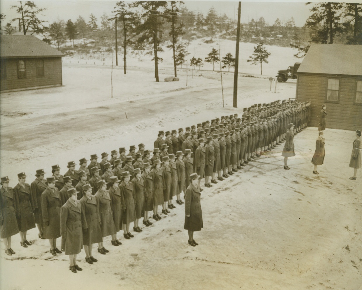 ROLL CALL FOR THE WAACS, 1/3/1943. FORT DEVENS, MASS. – The entire company of WAACS stationed at Fort Devens, assemble for roll call on the snow-covered grounds of the Fort, and a mighty fine-looking group of soldiers they make. Credit: Signal Corps photo via OWI Radiophoto from ACME;