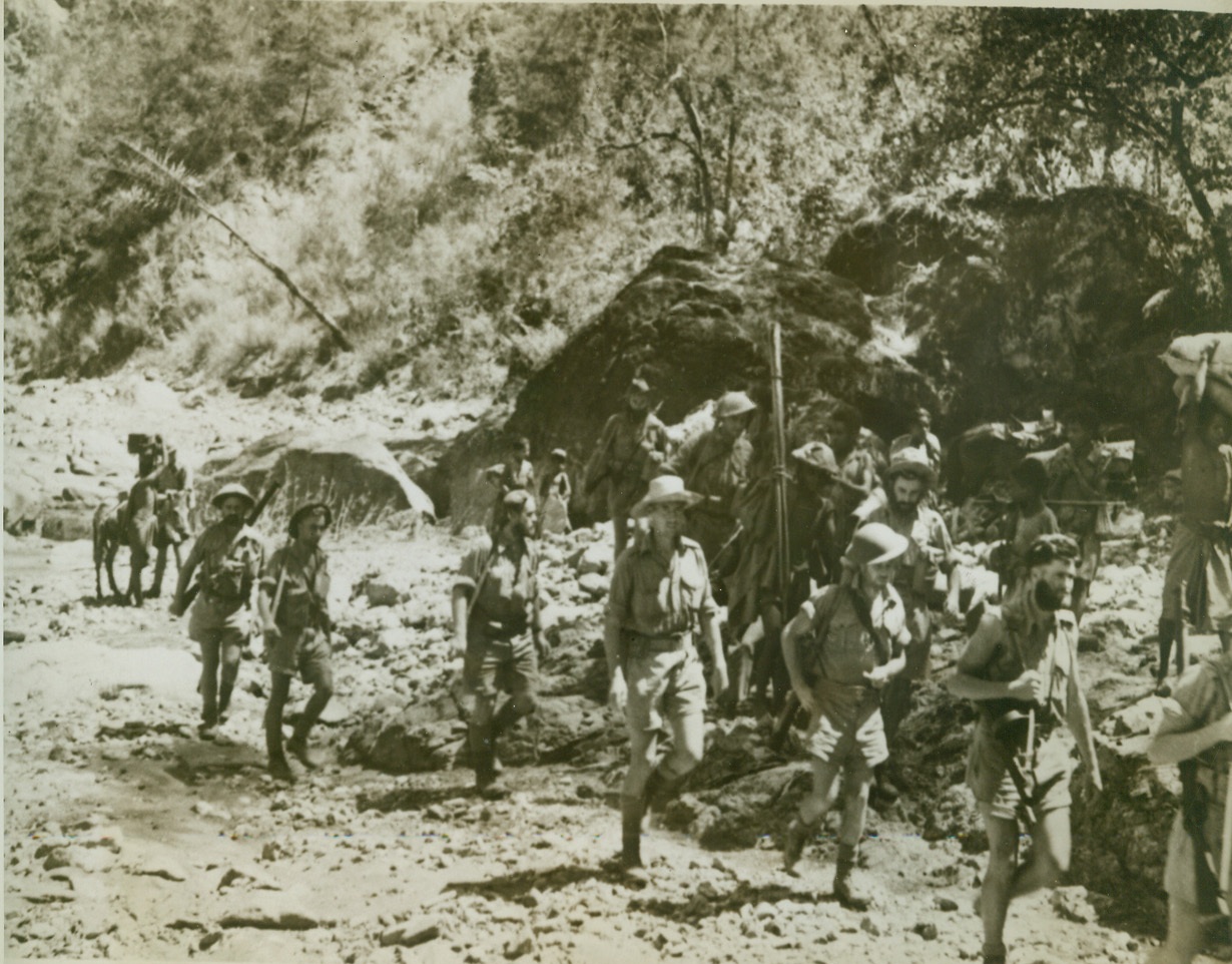AUSSIE GUERILLAS SWAT – THEN DODGE, 1/25/1943. TIMOR ISLAND – A Battery of Australian Guerillas move on, after accomplishing a lot of dirty work on Nips and their strongly entrenched installations on Timor Island. The Aussies, living on Timor Island with the enemy, use hit and run tactics against the forces which vastly outnumber them. Credit: ACME;