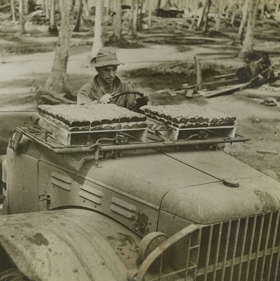 Guadalcanal Baker Boy, 1/29/1943. Guadalcanal - - Sweet rolls stacked on the windshield of this U.S. Army truck, are rushed from the bakery to hungry American fighters on Guadalcanal.  Today, U.S. ground forces on the island consolidated their position at Kokumbona, killing 293 more Japs.Credit Line (ACME);