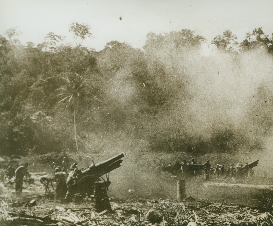 Artillery in Action on Guadalcanal, 1/19/1943. Guadalcanal: - 155 mm howitzers pour shells on enemy lines from advanced positions in Guadalcanal, where U.S. Marines are leading the attack on Jap forces.  Latest reports state U.S. ground forces on the island continue to mop up pockets of enemy resistance.  This photo is from a Marine Corps’ newsreel. Credit (U.S. Marine Corps newsreel photo – ACME);