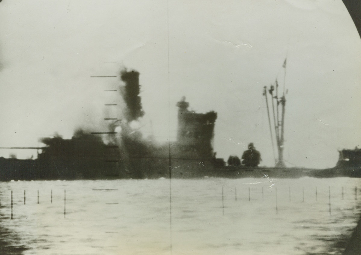American Submarines Attack Japanese Shipping, 1/23/1943. Attrition in Pacific Waters. Dealt a death blow by the U.S. submarine from which this periscope picture was snapped, an unidentified Japanese ship breaks out aflame amidship. The ship may have been used as a transport.;