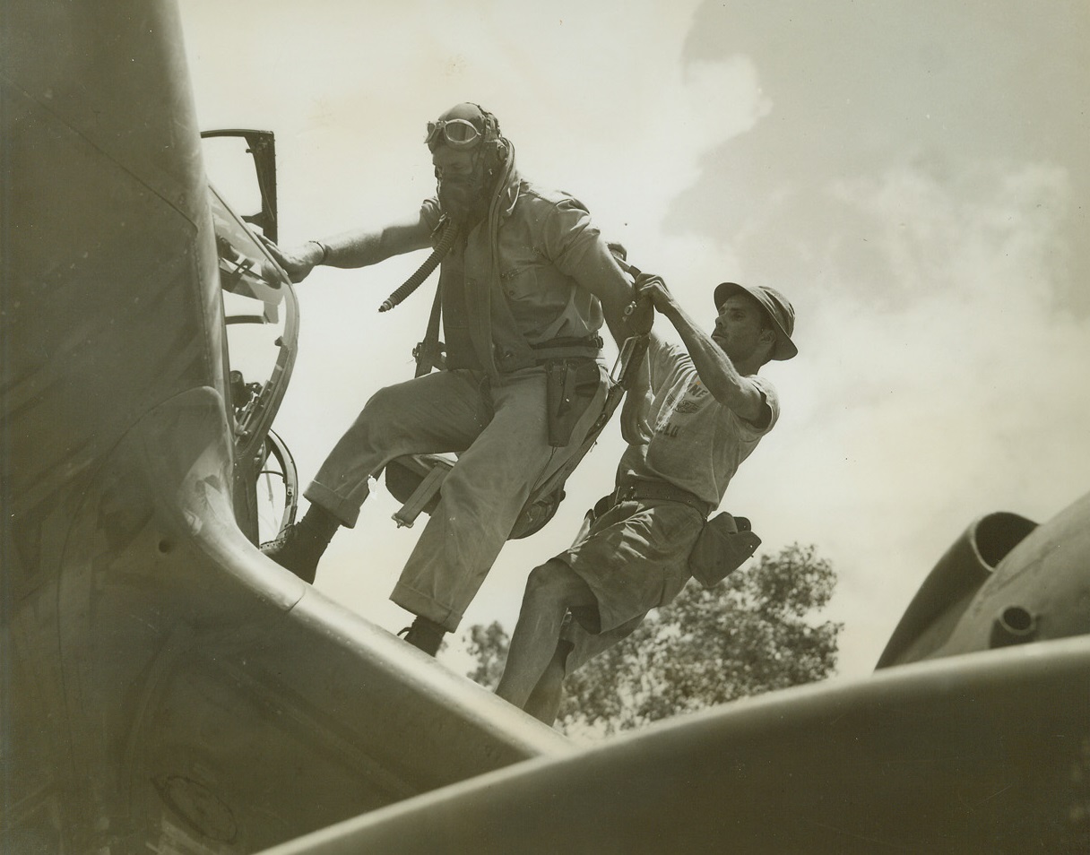 Getting Into His Chute, 1/10/1943. Port Moresby, New Guinea – A new fighter group with their speedy P-38’s are now on the job at Port Moresby.  Here 1st Lt. Robert Faurot, of Cape Girardeau, Mo., climbs into his chute before taking over the controls of his fighter plane. Credit line (ACME);