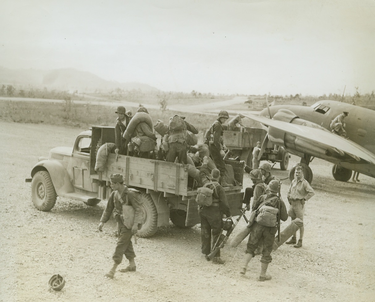 Planes Land American Infantry in New Guinea, 1/9/1943. Port Moresby, New Guinea – American infantrymen are shown as they were landed by a transport plane near here and transferred to their camp by truck – augmenting the American forces. Credit line (ACME);