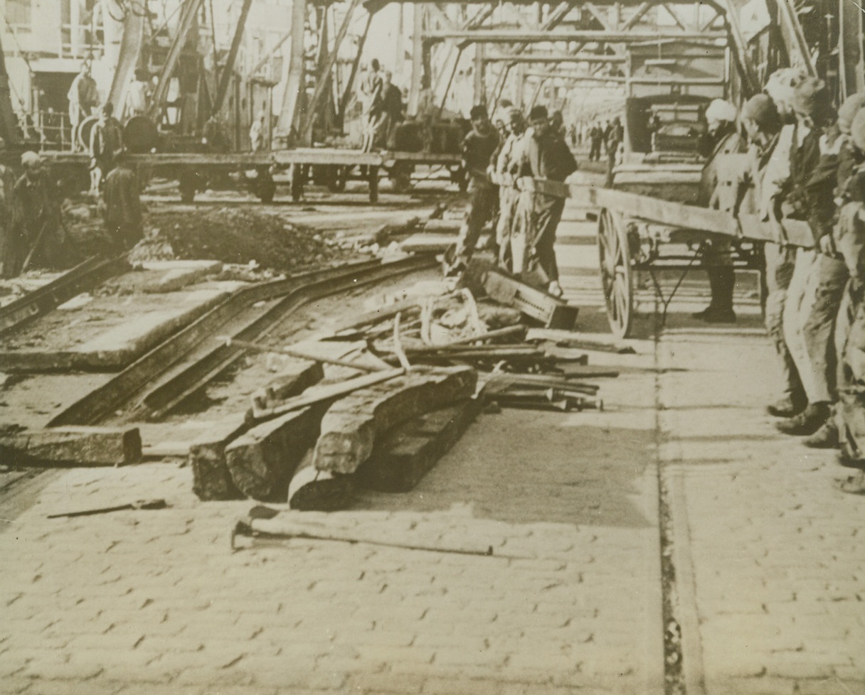 Tidying Up, 1/6/1943. Casablanca: - Native workers repair docks (above), roads, buildings and other traces of damage done by allied bombing attacks on the French Morocco seaport. Credit line (ACME);