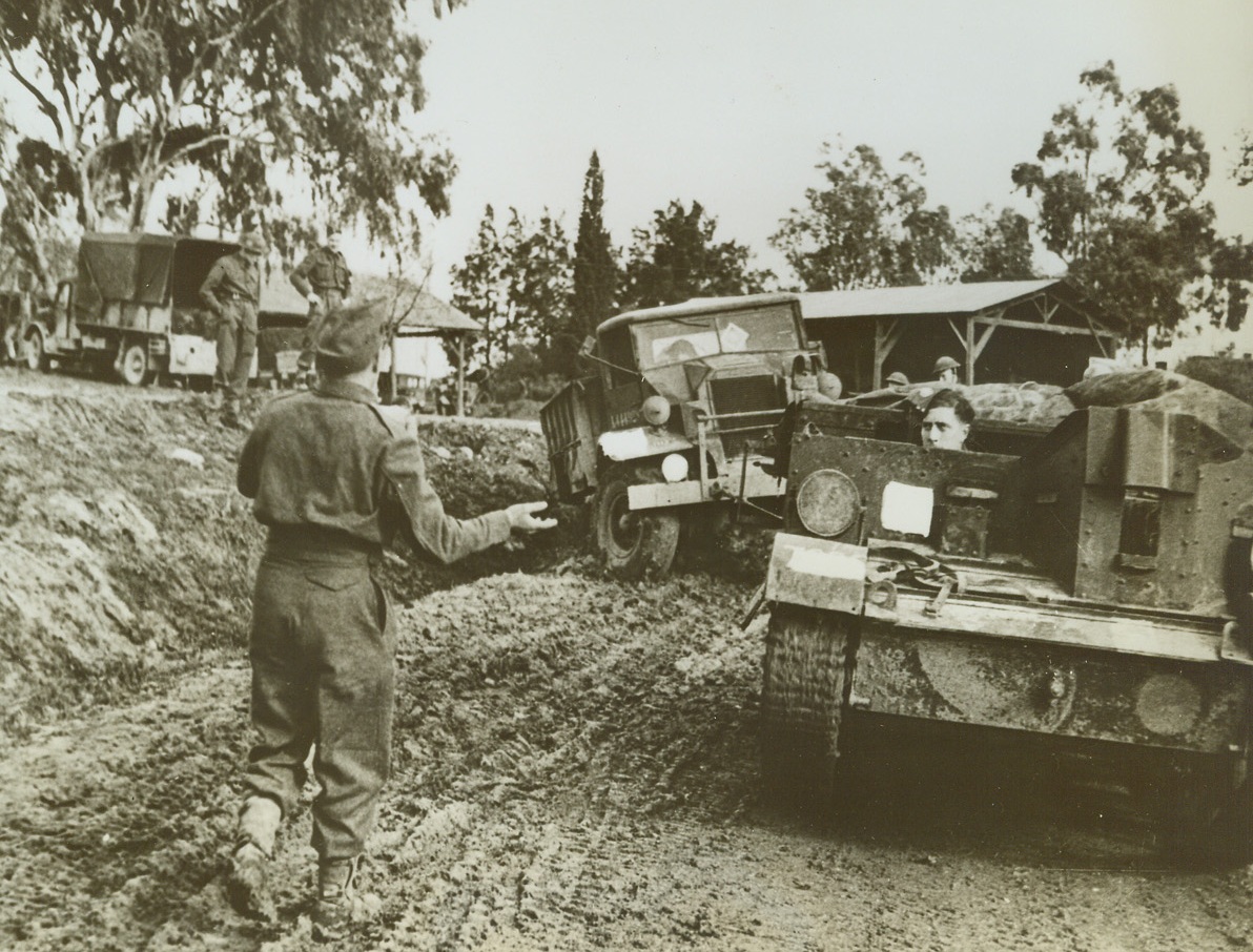 Mud Hampers Allies in Tunisia, 1/26/1943. Med Jez El Bab, Tunisia – Heavy rains on the Med Jez El Bab front in Tunisia have been slowing up allied operations in that sector by making the roads extremely muddy and hazardous for traffic.  Here, a lobby which has skidded a ditch is recovered with the aid of a Bren Carrier.  Axis reports said tonight that American troops were massing in force for an attempt to cut off Rommel’s coastal line of retreat in Tunisia. Credit line (ACME);