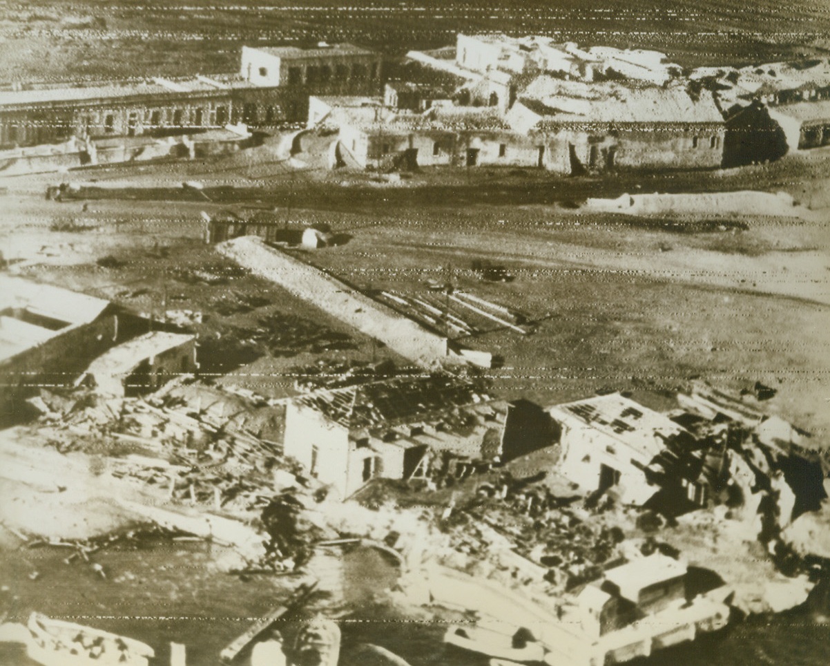 Waterfront at Tripoli, 1/27/1943. Tripoli – Damaged buildings on the waterfront at Tripoli show where the bombs of the RAF and the USAAF found their mark.  Latest reports from Tripoli indicate that forces of the British eight Army have captured Ez Zauia, thirty miles West of Tripoli. Credit line (ACME Radio photo);