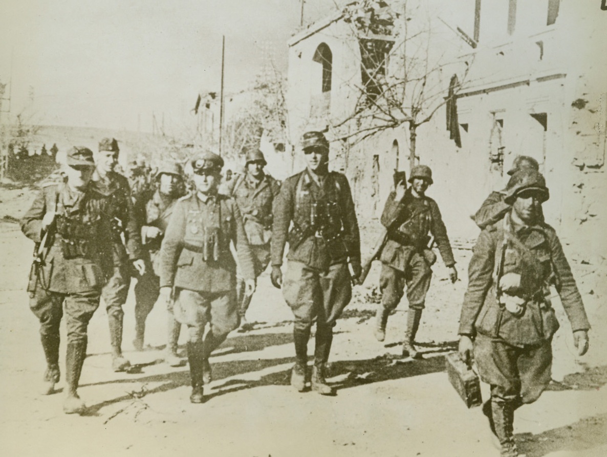 After the Battle, 1/9/1943. Tebourba, Tunisia – A German Panzer General and his staff walk through the city of Tebourba after engaging American and British troops in a fierce battle in that area.  Photo was received through sources in neutral Portugal.  Latest dispatches from Tunisia reveal that Allied bombers attacked the Docks at Tunis on the night of Jan. 6-7;