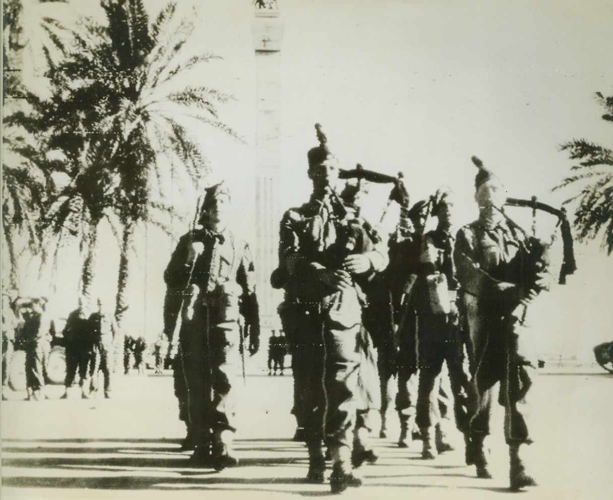 First Photos of Tripoli’s Fall, 1/25/1943. Tripoli—Men of the Gordon Highlanders as they marched into Tripoli with other units of the victorious British Eighth Army, as the once-proud center of Mussolini’s North African Empire was abandoned by German Marshal Rommel’s fleeing Afrika Korps. This photo, transmitted by radio, was one of the first to reach New York after Tripoli’s fall to the Allies. (Passed by censors)Credit: ACME radiophoto;
