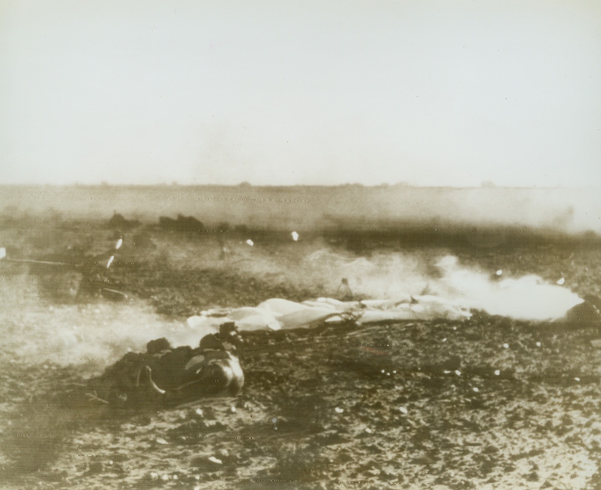 German Pilot’s ‘Chute Didn’t Open, 1/25/1943. North Africa—Radiophoto shows the pilot of a Ju-87 bomber lying dead beside the wreckage of his plane. He hit the ground before his parachute was fully opened after being shot down. Photo flashed from Cairo at noon.Credit: ACME radiophoto;