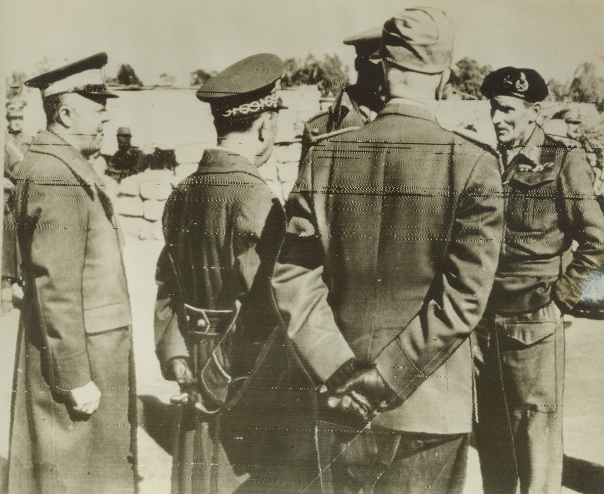 First Photos of Tripoli’s Fall, 1/25/1943, Tripoli—General Bernard L. Montgomery (far right), commanding the British Eighth Army, as he dictated terms to the Governor of Tripoli town and Tripolitania at Castel Benito Gate, as the victorious Allies swept into the once-proud center of Mussolini’s North African Empire. This photo, received by radio in New York today, is one of the first to be transmitted after Tripoli’s fall. (Passed by censors)Credit: ACME radiophoto.;