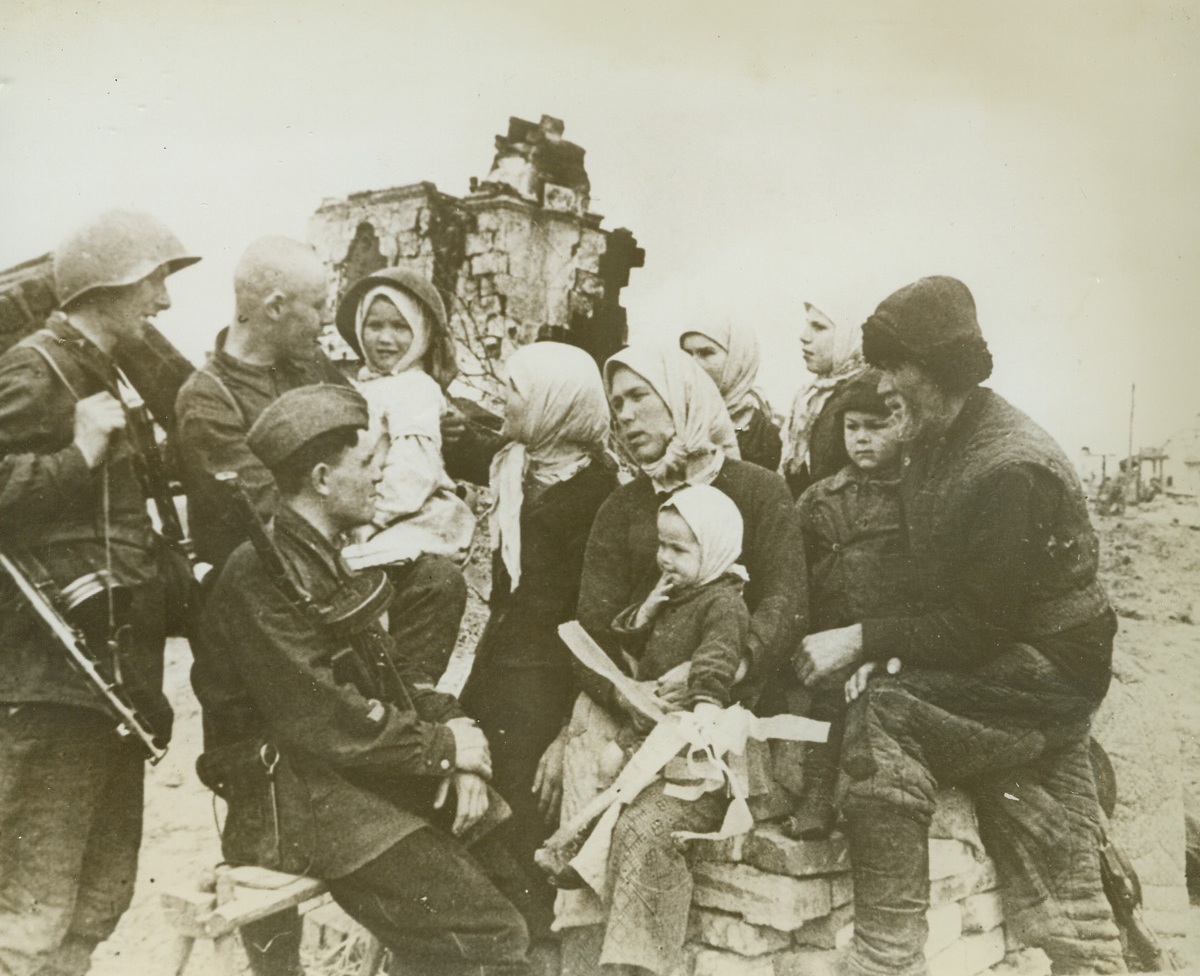 Home-coming Near Stalingrad, 1/18/1943. Russia—The sufferings of war written on their faces, survivors of families occupying a collective farm to the northwest of Stalingrad tell of their experiences after their village had been recaptured by Russian advance troops. Credit: ACME.;