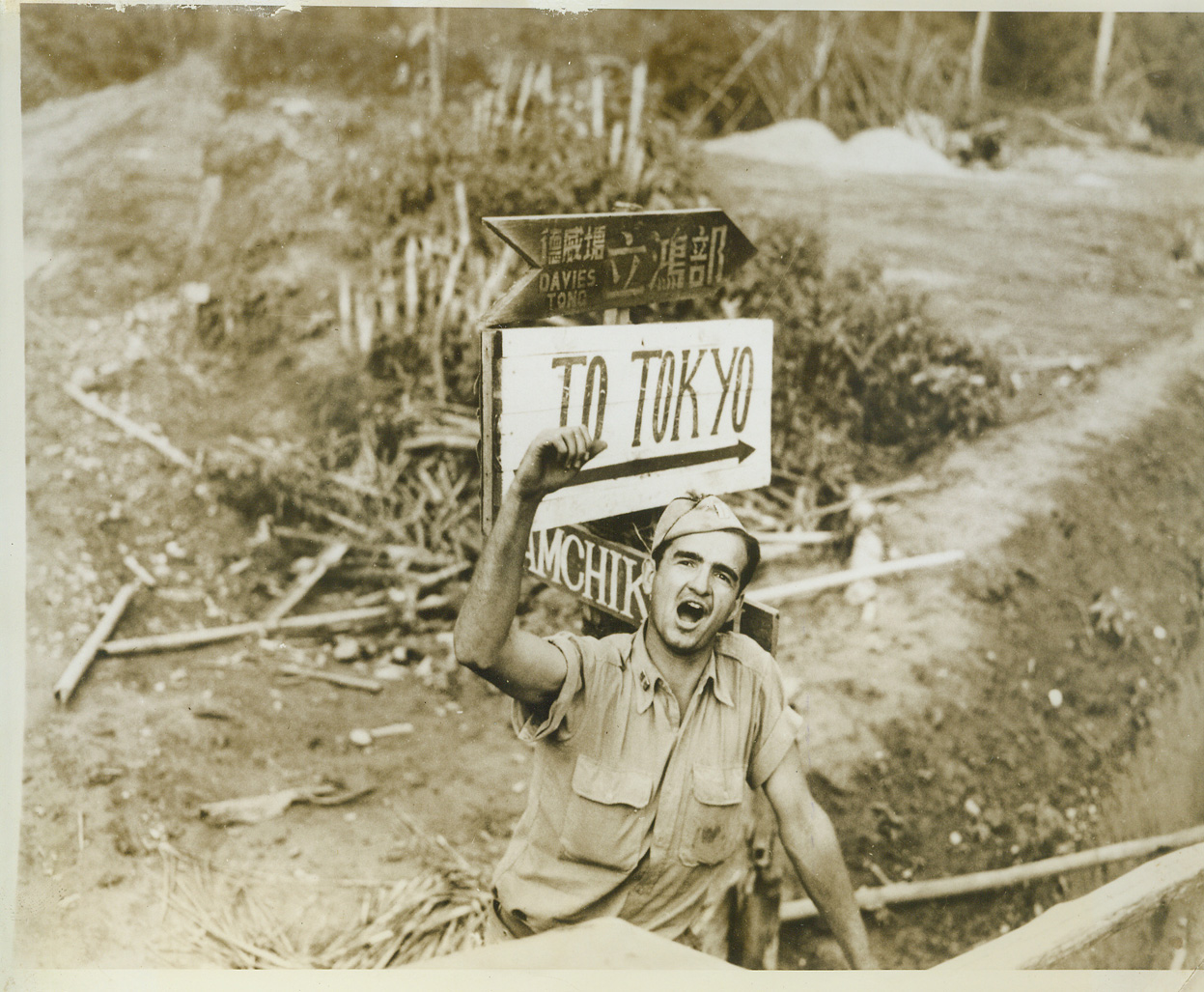 New Burma Road - Shortcut to Tokyo, 9/28/1943. ASSAM, India - Captain John E. Moyer, of Tuskegee, Ala., one of many U.S. Army Engineers working on a new branch of the Burma Road, points out the direction which United Nations moving over the road, will eventually take - to Tokyo. The road starts at Assam, will cross the North Burma border and on into Central Burma, where it will connect with the Old Burma road, now blocked by Jap occupation. The new road was begun last December.;