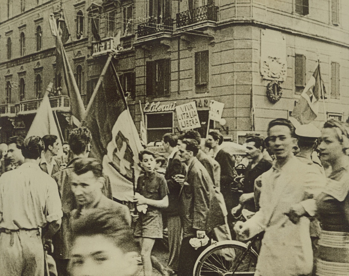 The People Rejoice, 9/17/1943. ROME—Milling through the streets of Rome, carrying banners and placards, the Italian people celebrate the downfall of Benito Mussolini, soon after his “resignation” was announced, on July 25th. This photo is from an Italian newsreel, obtained through a neutral source. Credit: ACME.;