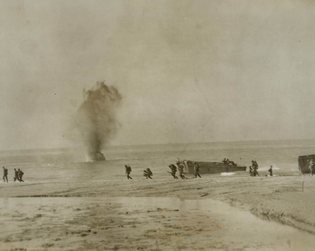 Shelling Our Boys on the Beach, 9/24/1943. IN THE NAPLES AREA – An enemy shell sends a geyser of water shooting up in the background as Allied soldiers land in the Naples area. As the shells fly thick and fast, the boys scamper up the beaches, from landing craft. Credit Line (Photo by Charles Corte, ACME Photographer for War Pool);
