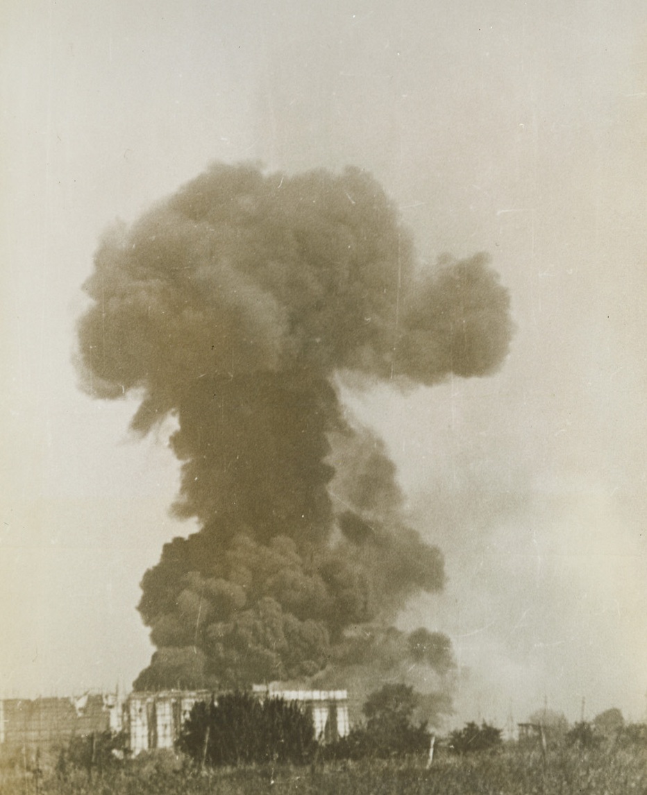 Artillerymen’s Work, 9/25/1943. ITALY – A thick curtain of smoke shoots up from an Italian tobacco factory building as Allied artillery shells find their mark. The building was being used by Germans as an artillery observation post. Our shells first battered the walls and roof in, and later they ignited what was probably an ammunition dump, causing an explosion. Credit Line – WP – (ACME);
