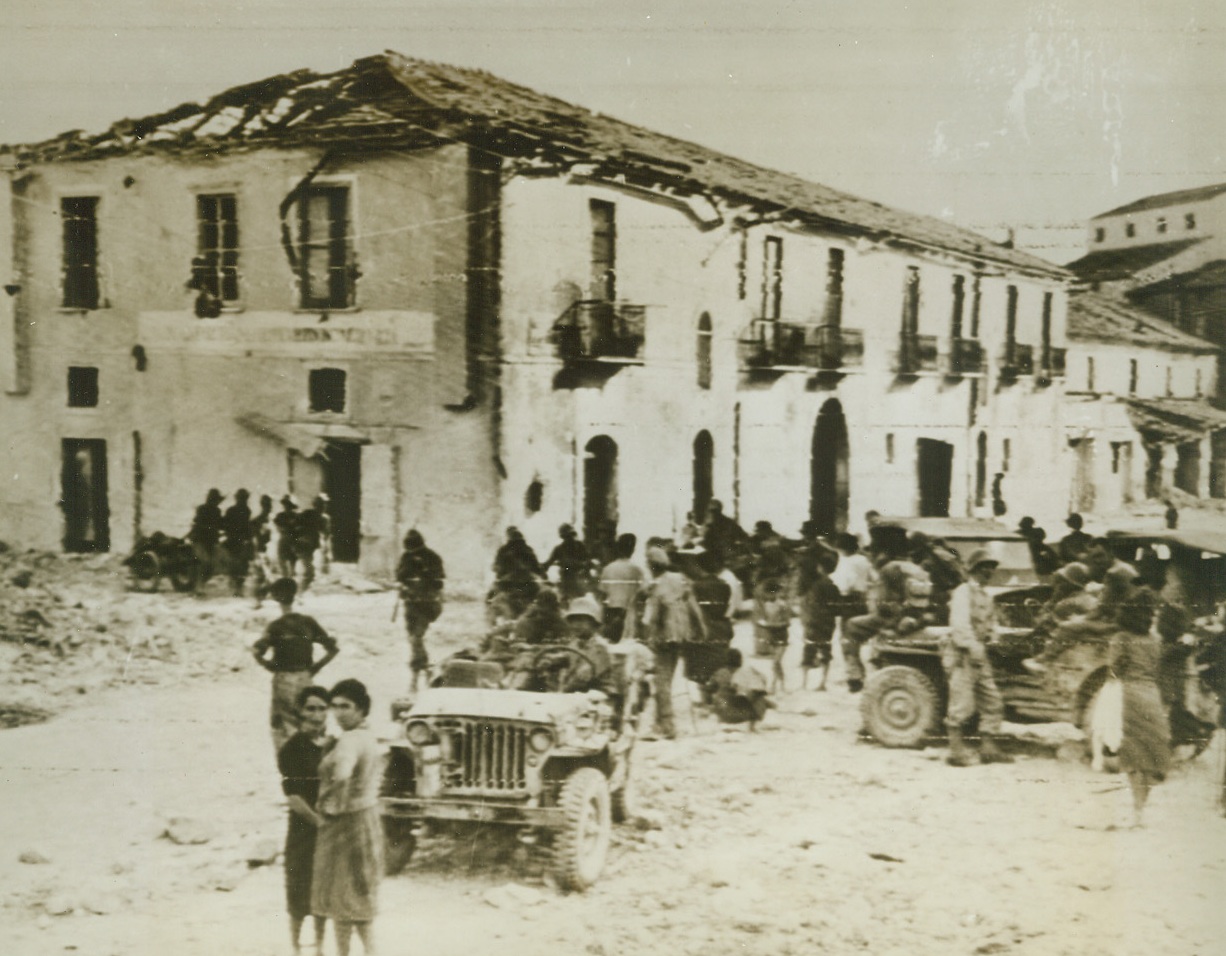 Americans Enter Eboli, 9/25/1943. EBOLI, ITALY – Curious Italian peasants come down to the streets to watch American troops roll through Eboli after occupying that strategic mountain city. Photo, by Acme photographer Charles Corte, was flashed to the U.S. via Radiotelephoto. Credit Line (Signal Corps Radiotelephoto – ACME);
