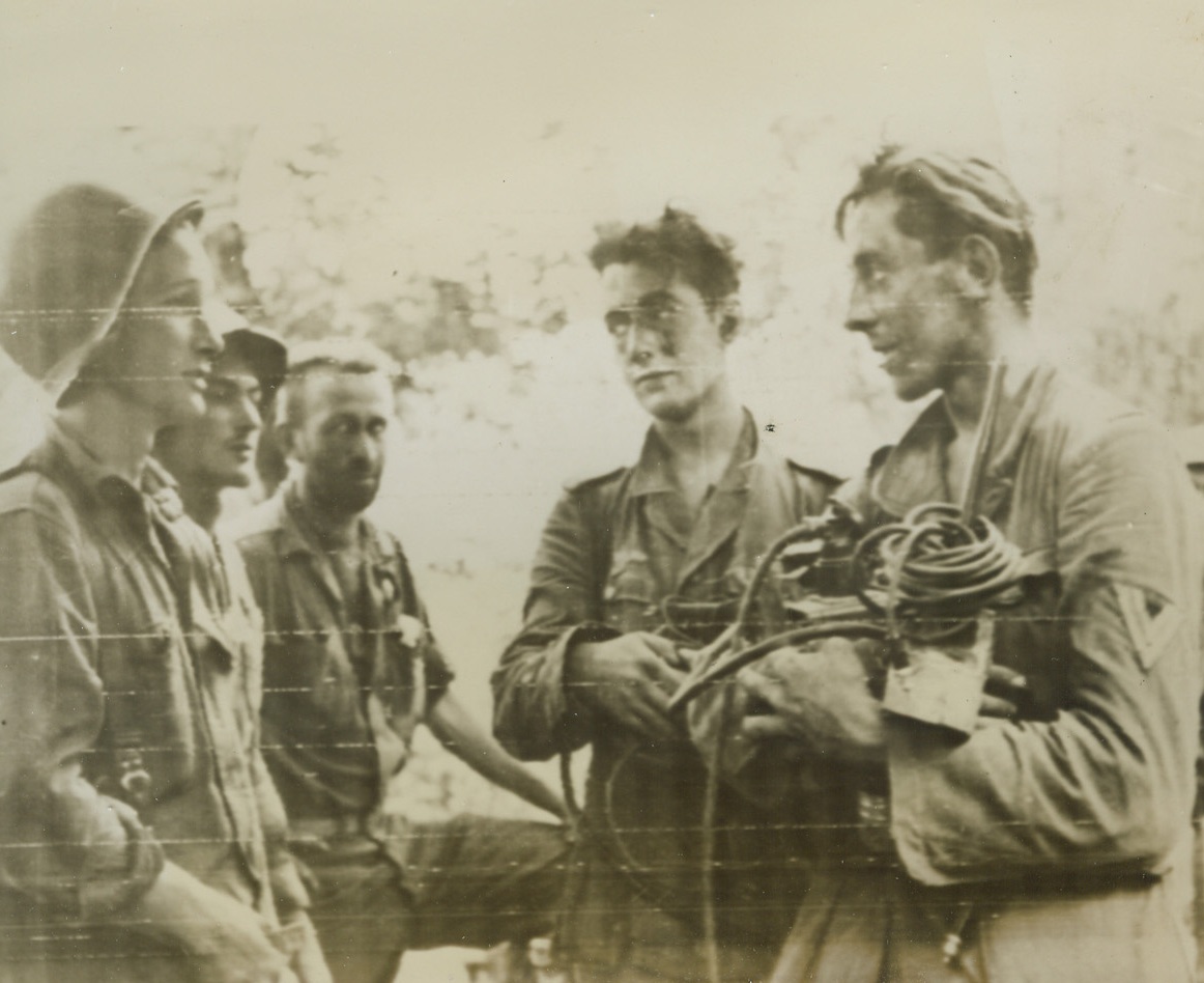 Captured Germans and Their Radio Equipment, 9/29/1943. The above photo, flashed to the United States by Radiotelephoto, shows Pfc. Ruby Asman, of Los Angeles, Calif., (extreme left) talking with two German prisoners who are holding radio equipment taken from the armored vehicle in which they were captured during the Italian campaign. Credit Line (Official US Army Signal Corps Radiotelephoto from Acme);