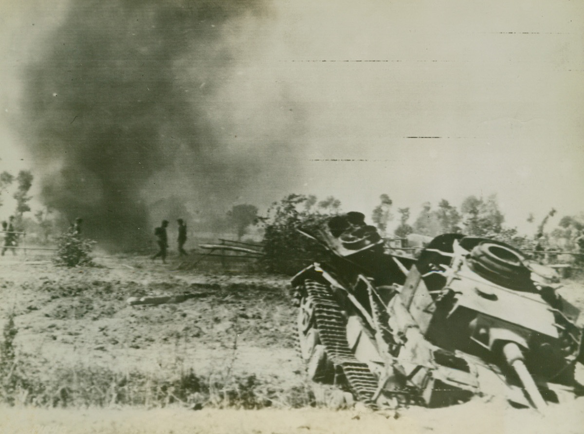 As We Invaded Italy – First Photo, 9/13/1943. The above picture flashed to the United States by Radiotelephoto shows a tank wrecked during the landing operations on Italian soil. Infantrymen (in background) are advancing through still burning fields. Credit Line (Acme Photo by Charles Corte for the Picture Pool via U.S. Army Signal Corps Radiotelephoto);