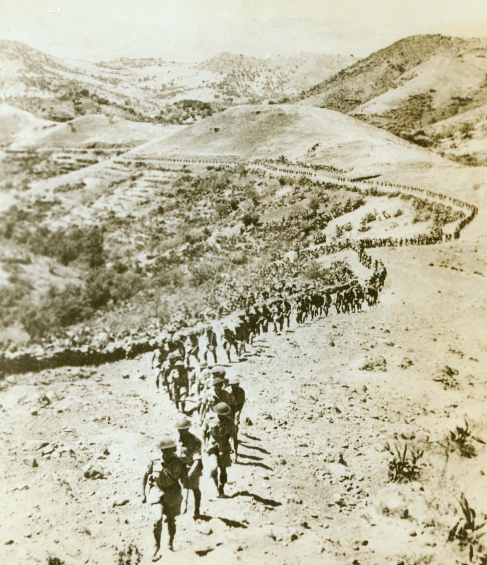 Highlanders Trek, 9/10/1943. SICILY – Tramping single file over the rocky slopes of Sicily, Vancouver’s Seaforth Highlanders follow their commander to an assembly point on the conquered island. With others who fought in the Sicilian Campaign, they were addressed by General Sir Bernard L. Montgomery, commander of the British Eighth Army. CREDIT LINE (ACME) 9/10/43;