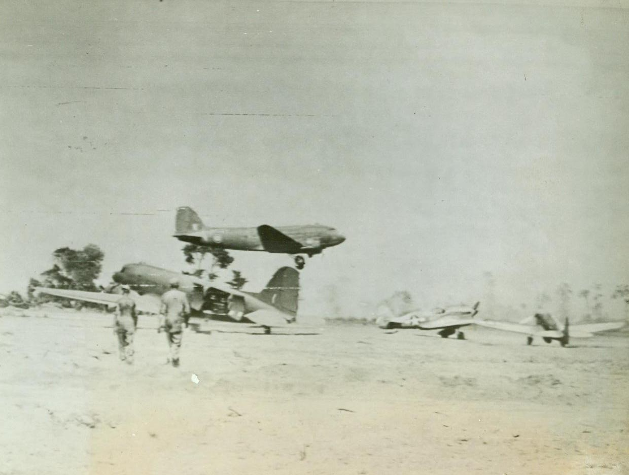 Advancing In Italy – Air Transport At Work, 9/19/1943. The above photo flashed to the U.S. by Radiotelephoto shows an Allied transport taking off from a rough, improvised landing field in Italy after discharging its cargo of men and materiel. Fighting planes may be seen scattered over the field. 9/19/43 Credit Line (U S Army Signal Corps Radiotelephoto From ACME);