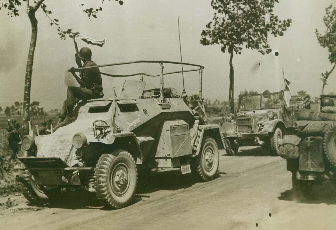 CAPTURED CARS WAVE WHITE FLAGS, 9/18/1943. ITALY—American soldiers, driving captured German armored cars back from the front, wave white flags to avoid being shot by Yank gunners. The cars were taken during early engagements with the Nazis on the Italian mainland. Credit: Acme;
