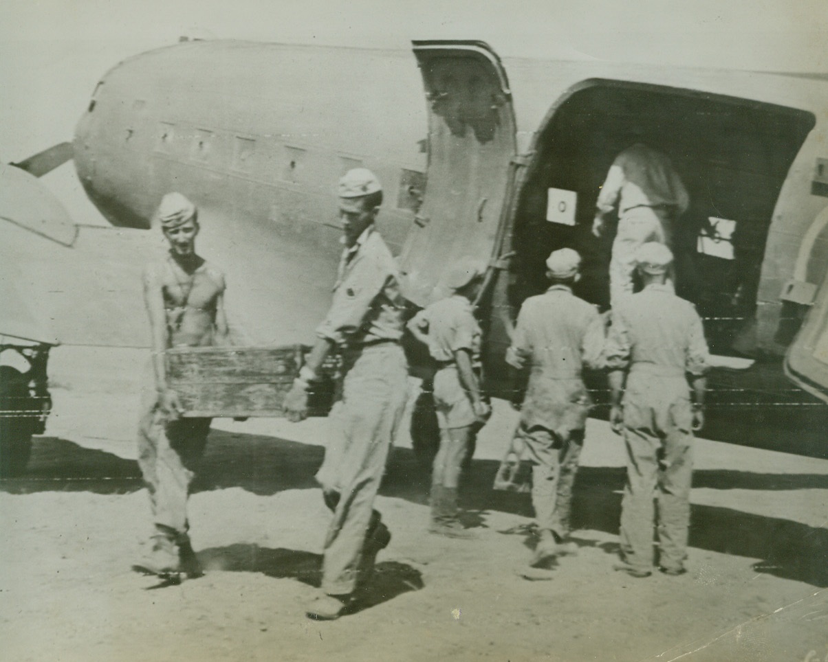 MATERIEL TO FURTHER ITALY’S INVASION, 9/19/1943. The above photo flashed to the U.S. by radiotelephoto shows enlisted men of a fighter group of American soldiers unloading an Allied transport plane that landed on a narrow strip of beach on Italian soil as we battle our way inland. Credit: U S Army Signal Corps radiotelephoto from Acme;