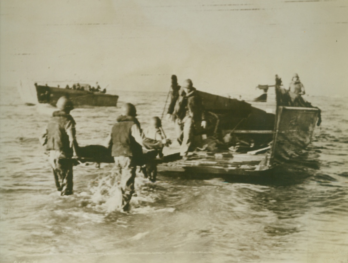 REMOVING U.S. CASUALTIES FROM SALERNO, 9/16/1943. American soldiers wounded in the bloody fighting in the Salerno area, are removed by litter to landing barges for transportation to base hospitals far from the scene of battle, in this photo flashed to the United States by radiotelephoto today, as it was announced that forces under Lt. Gen. Mark W. Clark are driving the Germans back in the Salerno area. Credit: U.S. Signal Corps radiotelephoto from Acme;