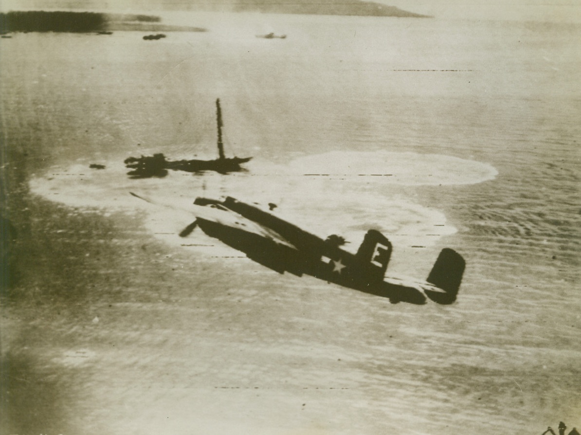 IN FOR THE KILL, 9/2/1943. SOUTH PACIFIC—A United States medium bomber sweeps down for a last blow at a Jap vessel at Hansa Bay, New Guinea. The three large circles in the water mark near misses or arose from previous hits from the B-25. Credit (US Army Radiotelephoto from Acme);