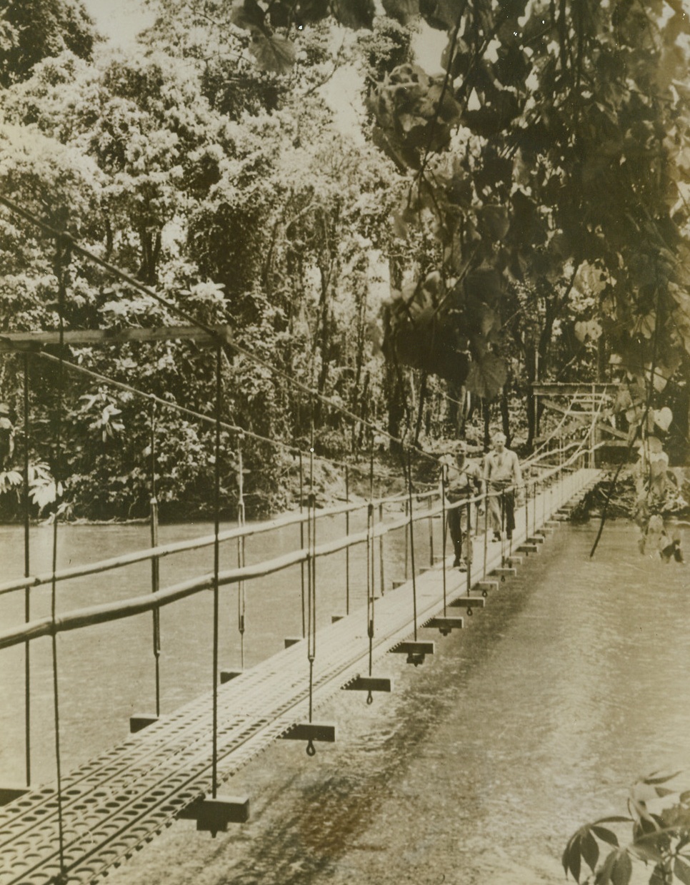 Bridge The Seabees Built, 9/29/1943. The Navy’s Seabees built this bridge across Matanikau, following the battle of Manitanikao River. The bridge enabled Marine Corps assault troops, plus small supply units, to make hurried crossings and reinforce units already in enemy territory. The bridge is constructed of steel matting, the same kind used on the runway of Guadalcanal’s Henderson Field. 9/29/43 Credit Line (U.S. Marine Corps Photo From ACME);