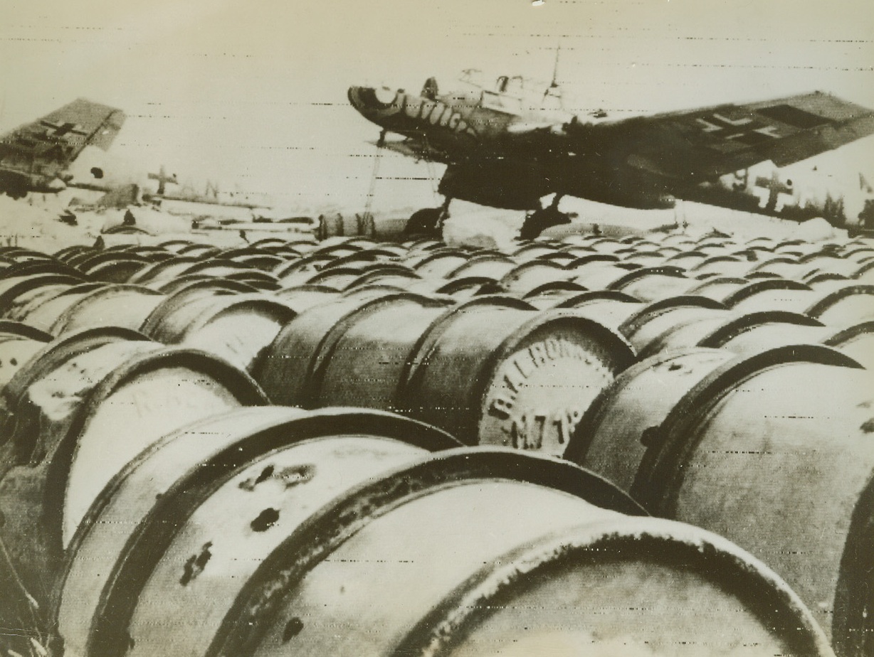 Nazi Airdrome Near Salerno Captured, 9/16/1943. This photo, flashed to New York by radio today, shows Nazi planes and barrels of oil on a German airfield in the Salerno area, after the base was captured by the forces of Lt. Gen. Mark W. Clark. Americans and British under Clark’s command, have held their bridgeheads in spite of the bloodiest fighting of the Mediterranean Campaign, and are today counter-attacking against the Germans. 9/16/43 Credit Line (OWI Radiophoto From ACME);
