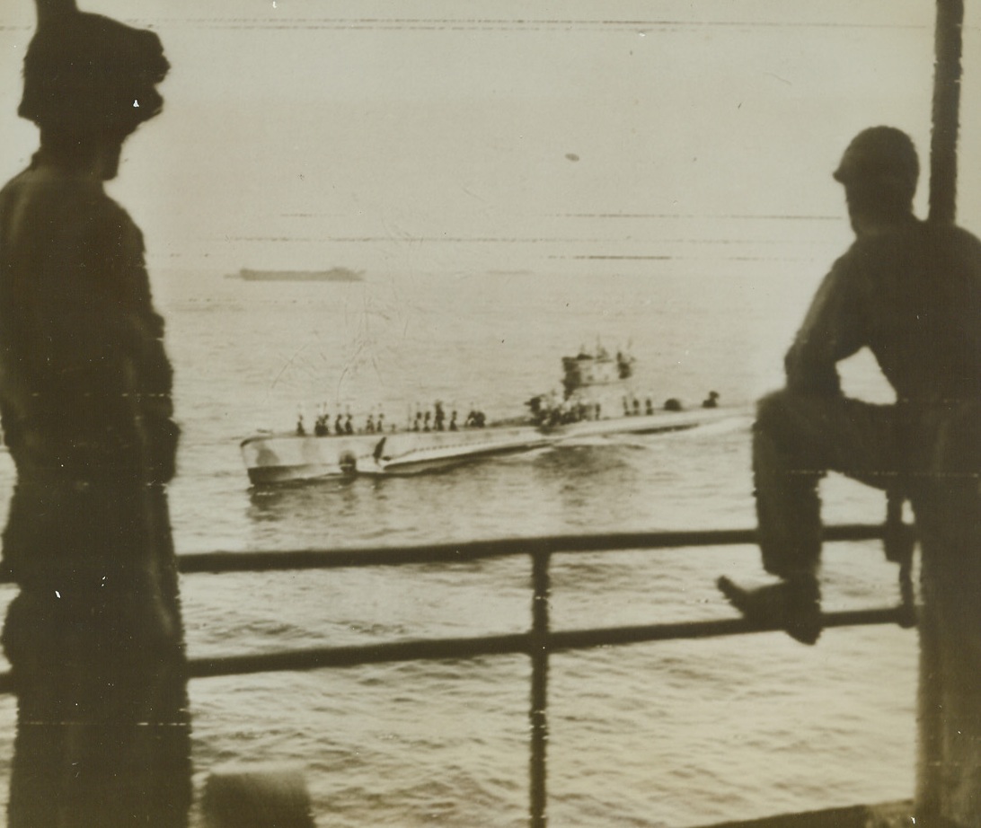 ON THE SAME SIDE, NOW, 9/16/1943. An Italian submarine on its way to an Allied Mediterranean port to surrender and join the United Nations Naval Forces, passes a ship of a huge Allied convoy bound for the invasion of Italy. This photo was flashed to the United States by Radiotelephoto today, as it was announced that forces under Lt. Gen. Mark W. Clark were forcing the Germans back in the Salerno area after eight days of the bloodiest fighting the Mediterranean area has seen.  Credit Line (U.S. Signal Corps Radiotelephoto from ACME);