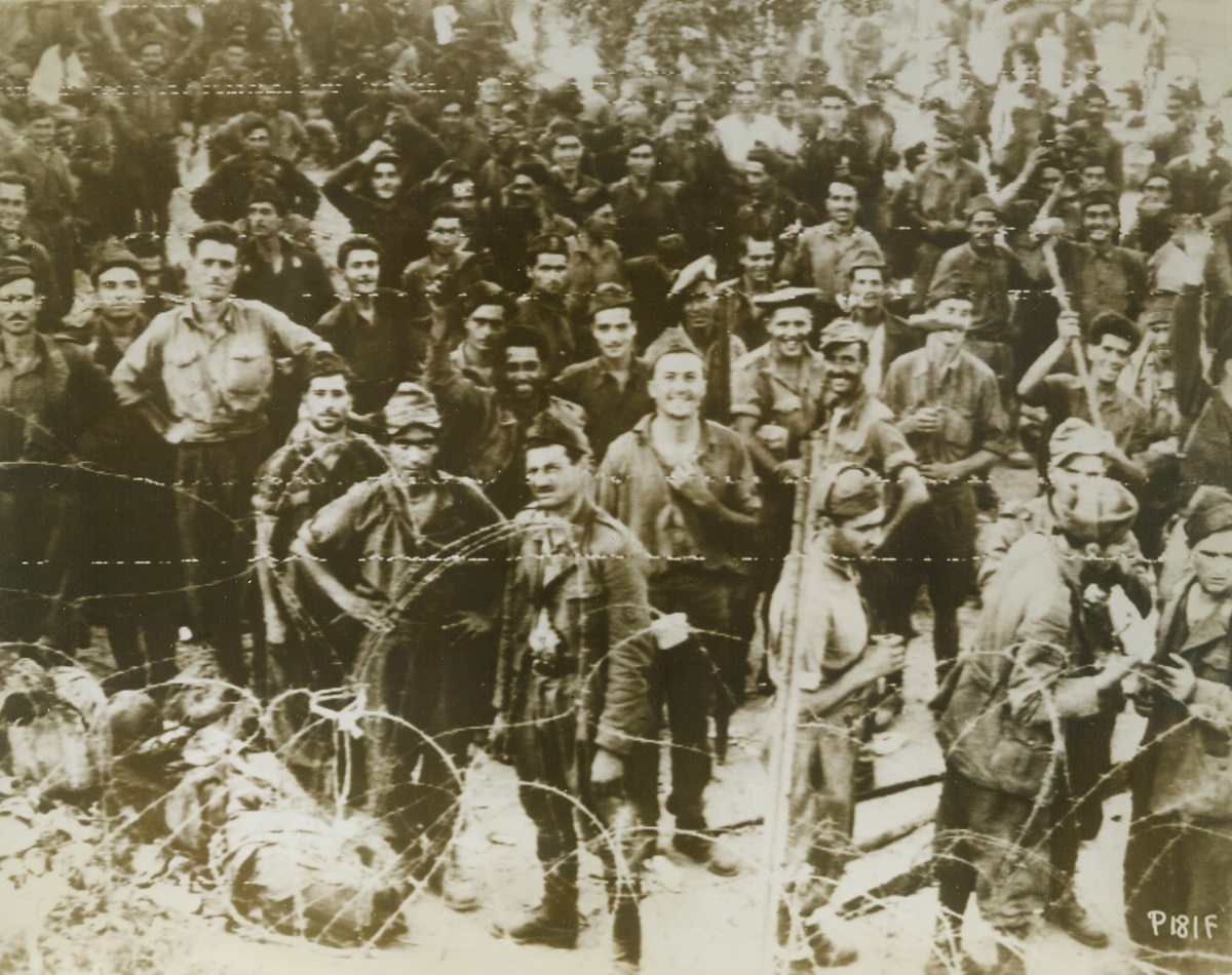 The Distinction of Being First, 9/10/1943. Italy – The first group of Italian prisoners to be taken in Italy proper are rounded up at Gallico, Marina, Italy, where they were captured by British Commandos in a raid from Mili-Marina, Sicily. Although the “unconditional surrender” armistice with Italy had already been signed, it was not yet announced when this photo was made at the Italian port. Credit: U.S. Army Signal Corps Radiotelephoto from ACME;