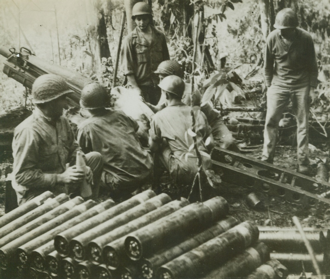 FUTURE MEDICINE FOR THE JAPS, 9/14/1943. NEW GUINEA—Parts of these guns, weighing from 100 to 250 pounds, made a perilous journey over the precipitous Lababia Ridge from Nassau Bay. They are in an ammunition dump of a U.S. battery in New Guinea. Credit: ACME.;