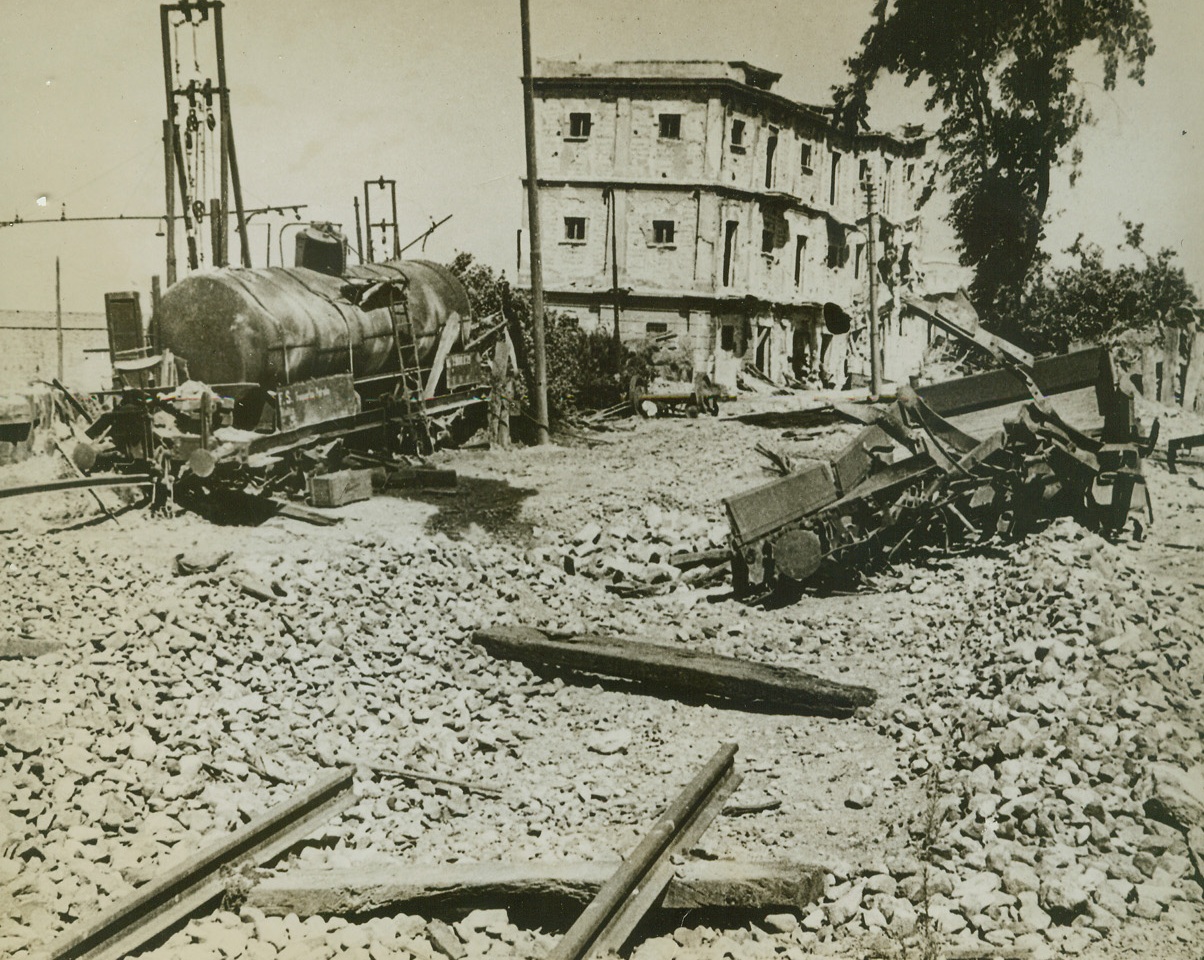 AFTER ALLIED TOOK REGGIO, 9/16/1943. This spot in Reggio Calabria, once a railway marshalling yard, has been converted to a rubble heap by heavy allied bombs and shells. In the background, the bombs have wrecked a concrete building. This photo, taken during the early stages of the Allied Invasion of the Italian mainland, has just reached the United States. Credit: ACME;
