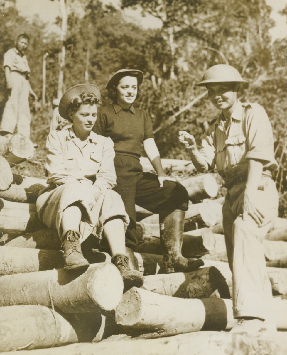 Army Nurses on the New Burma Road, 9/28/1943. Assam, India – Two U.S. Army nurses, Bernice Taylor, (left), of White cloud, Kansas, and Nancy Cooke, of Merion, Pa., have the new Burma road (nicknamed the “Tokyo road”), explained to them by a Chinese officer who supervises Chinese troops working on the new stretch of the road in central Burma after allied offensives have cleared the Japs from that sector.  Work on the project, which began last December, is being done under the direction of U.S. Army Engineers. Credit line (ACME);