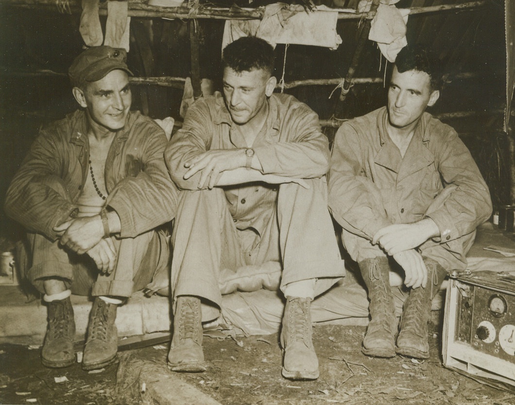 Practice Mercy Under Fire, 9/2/1943. New Georgia – Two fighting Marine Chaplains, both Catholic priests, Lieutenant Paul J. Redmond, of New Haven, Conn. (left), and Lieut. Comdr. John P. Murphy, of Chicago (right) went into action on the front lines with the Marines as they drove the Japs out of their garrisons at Enogai point New Georgia.  The two chaplains who frequently were targets for enemy snipers are shown with Col. Harry B. Liversedge, of Pine Grove, Cal., commanding officer.  After risking their lives to assist the raiders in reaching wounded, both later again faced death to go inside Jap lines to bury Marine dead.  Father Redmond is a former professor at Catholic University, Washington, D.C., and at Providence College, R.I. Credit (U.S. Marine Corps photo from ACME);