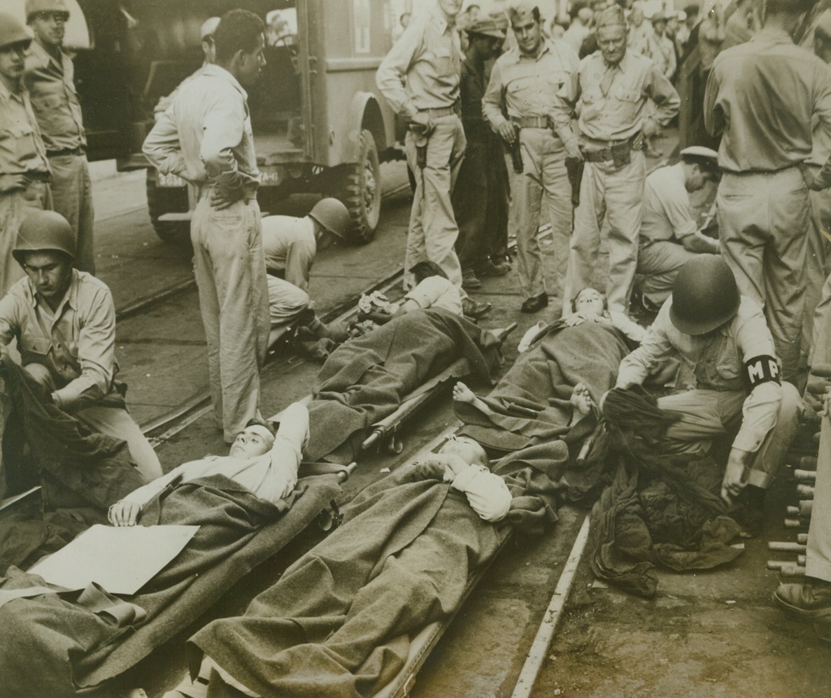 Nazis Head for U.S. – As Prisoners, 9/22/1943. Casablanca, French Morocco – Four wounded Germans captured by U.S. Army troops in the Northwest African Theatre, lie quietly on their litters as M.P.S check through their luggage, on this dock in Casablanca Harbor.  Shortly after photo was taken, the Germans were put aboard ship for America. Credit line (U.S. Army Signal Corps photo from ACME);