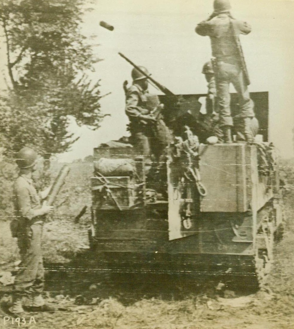 Direct Hit, 9/18/1943. ITALY – As the shell casing flies into the air, the crew of howitzer mounted on a half-track watched the shell they’ve just fired score a direct hit on an Italian tobacco factory, being used by the Germans as an artillery observation post. The crew, operating in the battle for the Italian mainland, is commanded by Sgt. Eugene Frey of Denver, Colo. CREDIT (U.S. Signal Corps Radiotelephoto from ACME) 9/18/43;