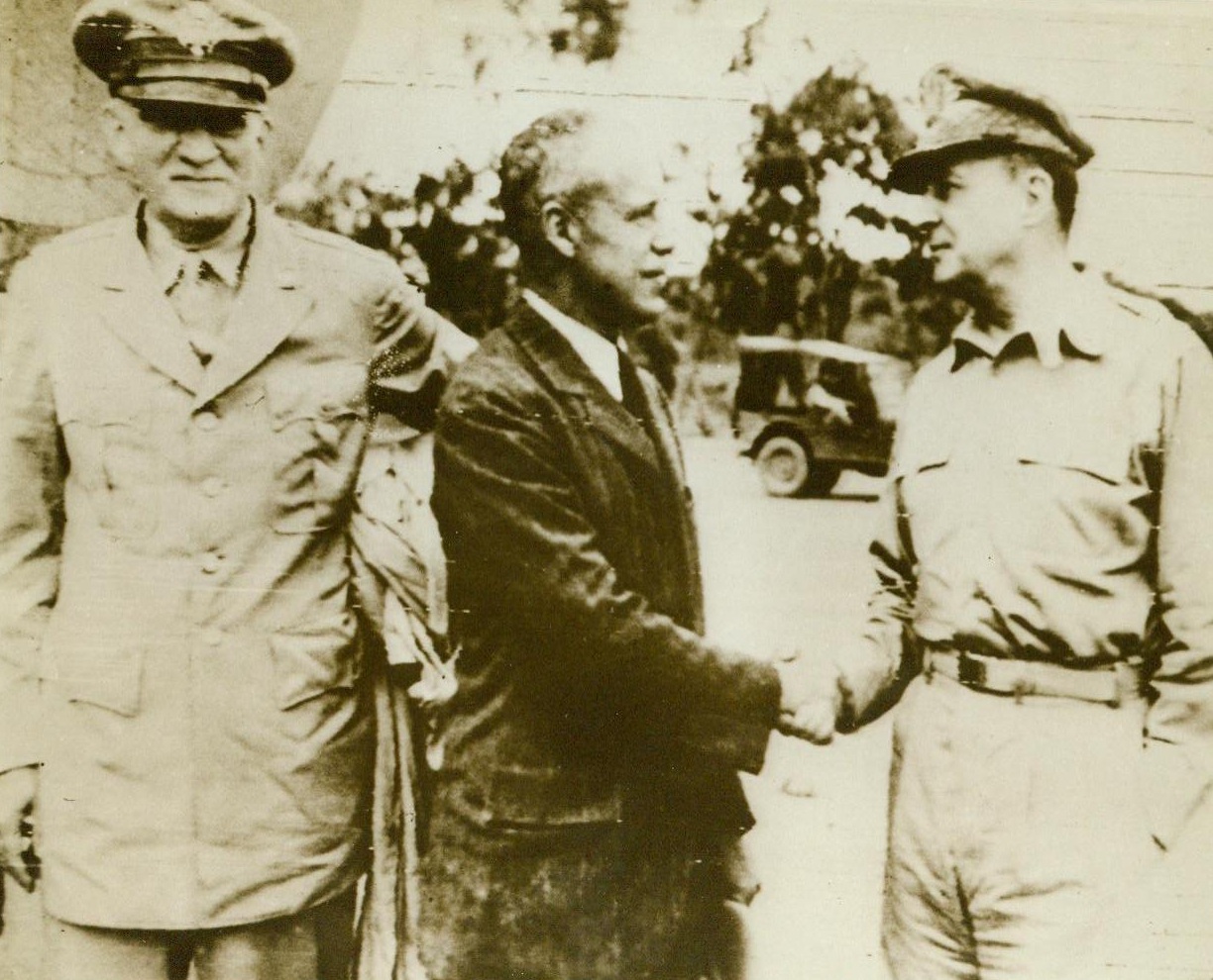Welcome To New Guinea, 9/2/1943. New Guinea—General Douglas MacArthur (Right) greets Under-Secretary of War Robert L. Patterson (Center) and Lieut. Gen. William S. Knudsen, at his headquarters somewhere in New Guinea. That South Pacific Island is now the scene of some furious war action as our forces close in on Japs entrenched at Salamaua. 9/2/43 (ACME);