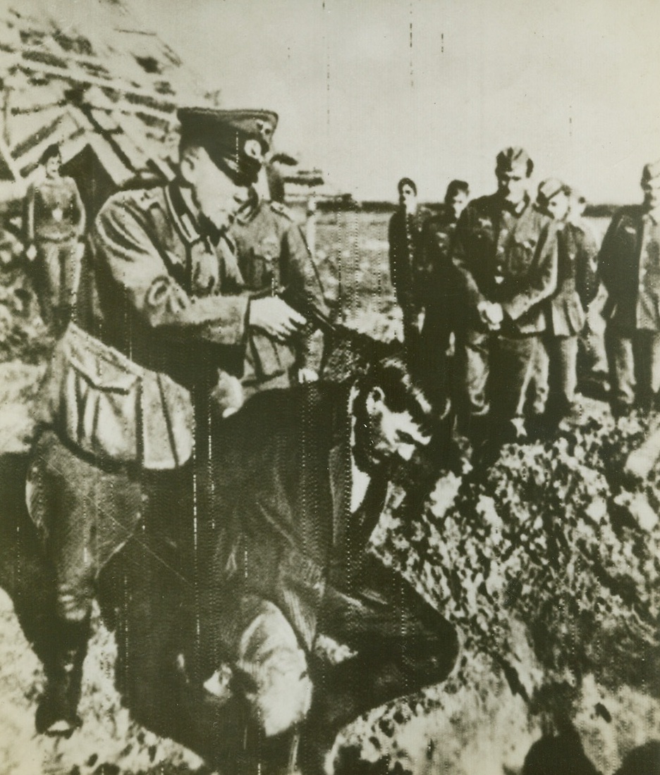 A Nazi Souvenir, 9/13/1943. RUSSIA – A Russian peasant crouches over his grave before being shot by a Nazi Gestapo agent, in this snapshot found on a German prisoner of war, one Pvt. Ludwig who served with a detachment of the 16th German Army. Although the determined Russian civilians need no further incentive to hate the Nazis, the photo was published in “Red Star.” Credit (ACME Radiophoto);