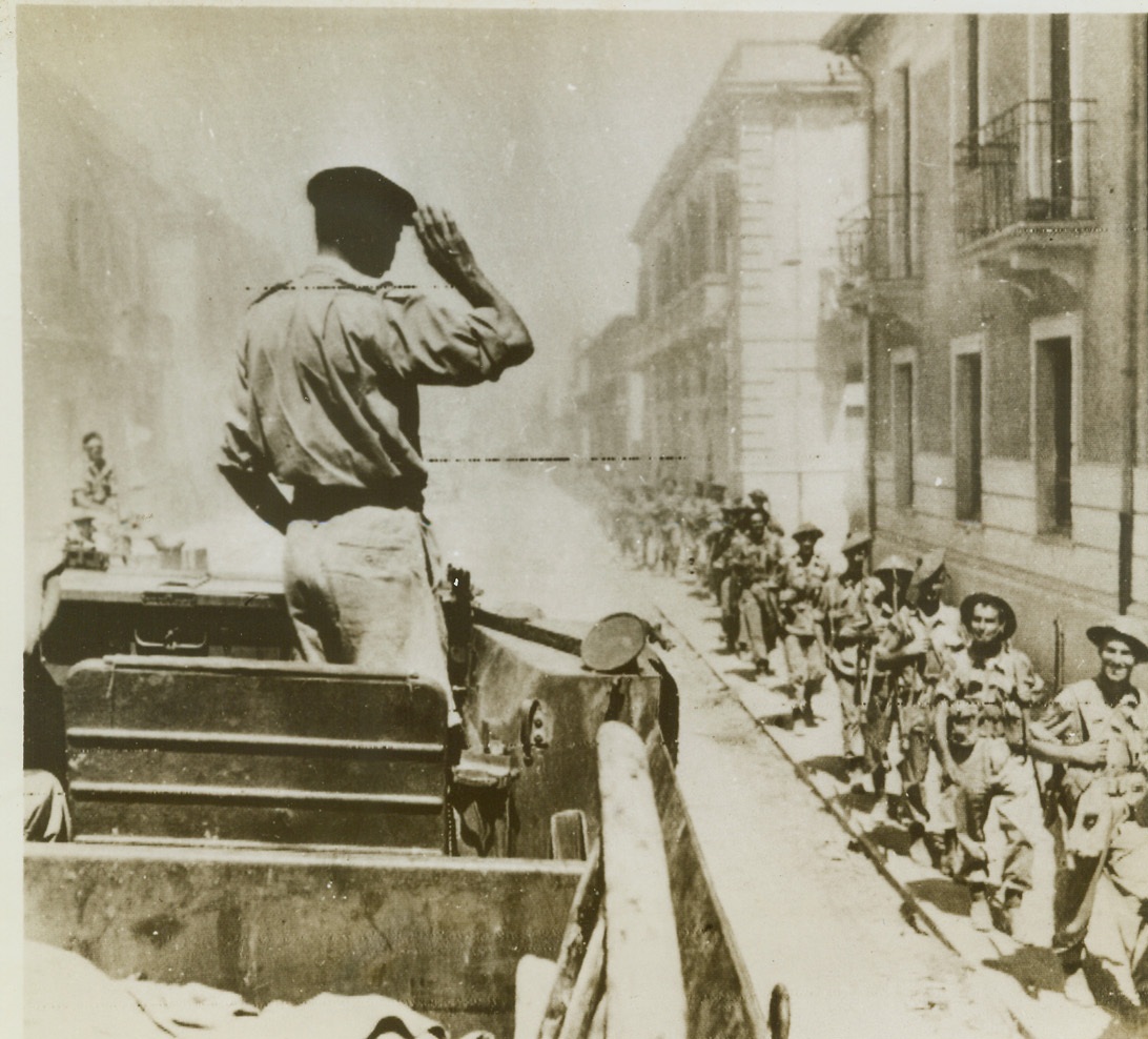 Victor’s Salute, 9/7/1943. Italy—General Bernard L. Montgomery, chief of the British 8th Army, salutes his fighting men as they pass through a street in Reggio Calabria. This is the first photo of the Allied foothold on the continent of Europe and since it was taken the 8th Army has driven steadily ahead on the Calabrian coastal road extending the invasion around Italy’s southernmost tip to about 60 miles. Credit: OWI Radiophoto from ACME.;