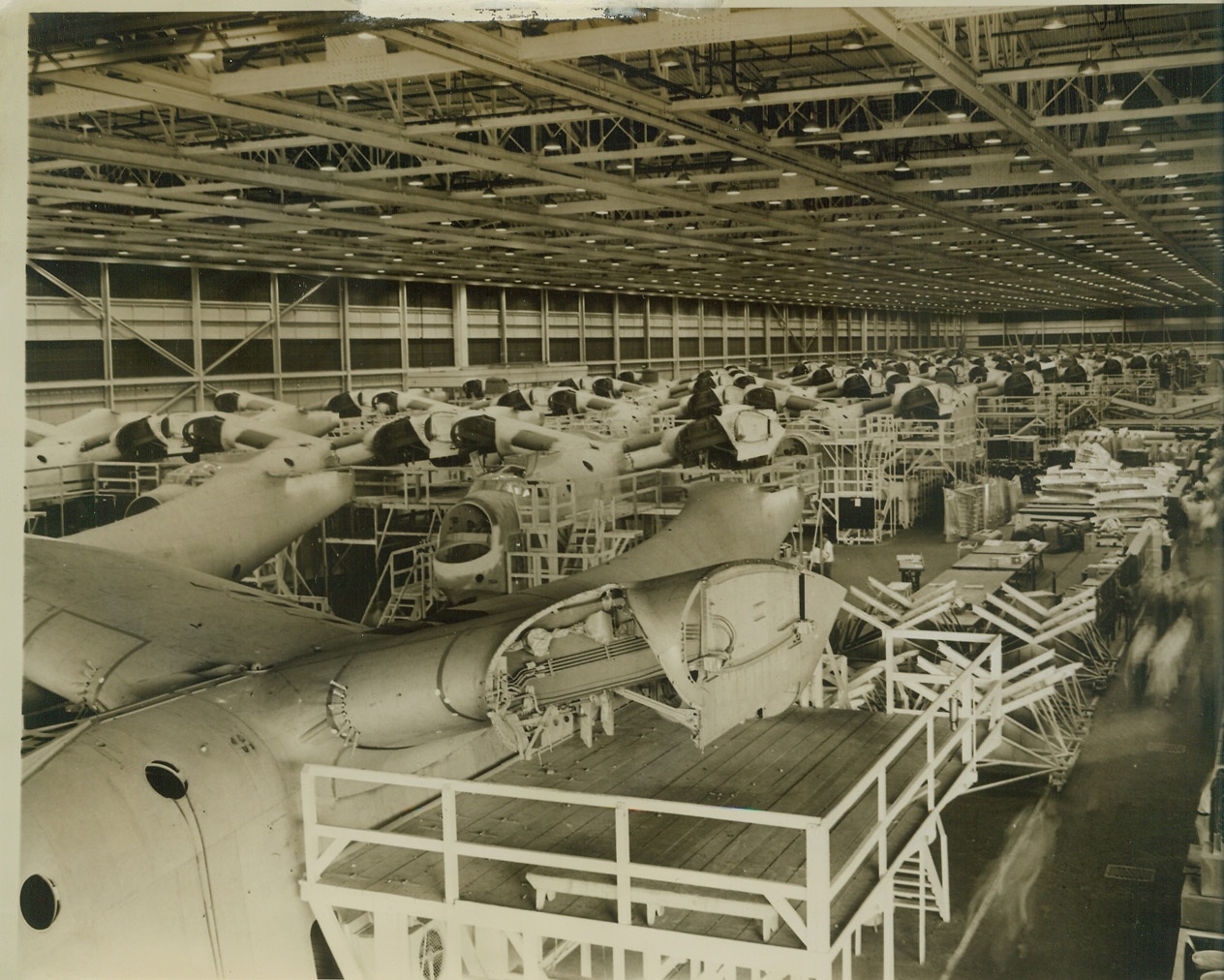 Where Mariner Patrol Bombers are Built, 10/4/1943. Baltimore, MD. – A view of the final assembly line of the Glenn L. Martin plant in Baltimore, where huge Martin PBM-3 Mariner patrol bombers are shown in the final stages of completion. Credit: (ACME);