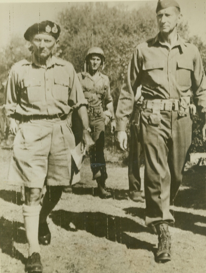 INSPECTING TROOPS AT ITALIAN FRONT, 10/2/1943. General Bernard L. Montgomery, Commanding General of the British Eighth Army (left), and Lt. Gen. Mark W. Clark, Commanding General of the American Fifth Army, are shown inspecting troops at the Italian Front. Credit: Signal Corps photo via OWI Radiophoto from ACME;