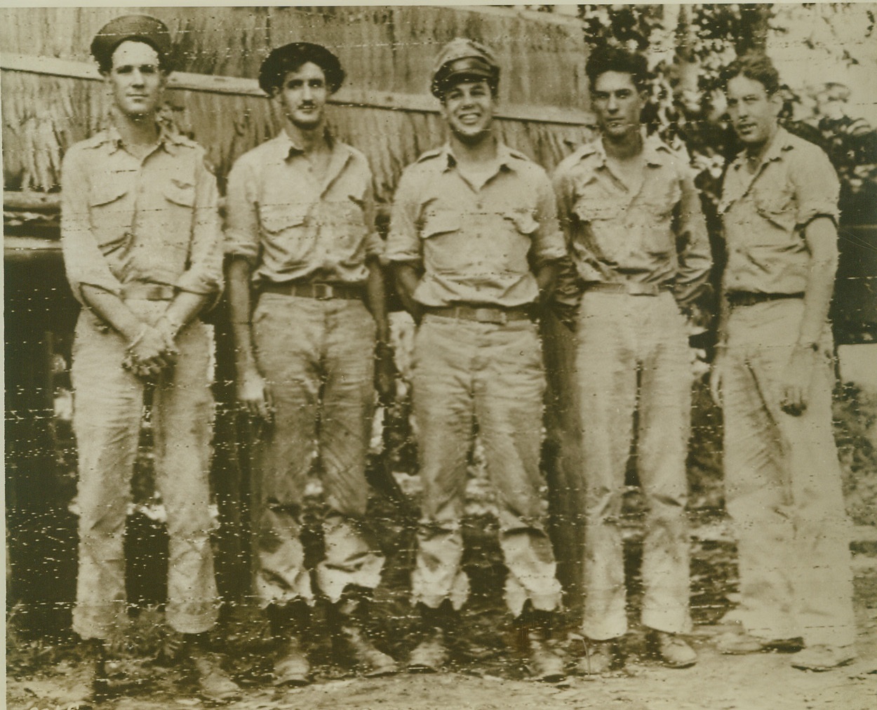 HELPED WIPE OUT JAP PLANES, 10/14/1943. These five U.S. pilots helped knock 177 Jap planes out of action at Raboul when every available plane in General MacArthur’s aerial arsenal dropped 350 tons of bombs on the base in New Britain. They are (left to right) Lt. Charles E. Moorfield, Arlington, VA.; Lt. Clifford P. Taylor, Woodhaven, L. I. N. Y.; Lt. Gilbert S. Stiles, Welty, Okla.; and Lt. Donald T. Lees, Rock Island, Ill. The pilot at right is unidentified. Credit: U.S. Army Signal Corps photo via OWI Radiophoto from ACME;