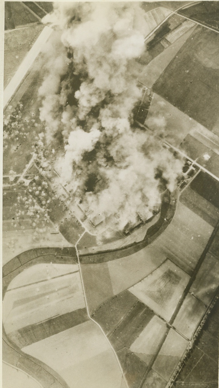 YANK BOMBERS BLAST MARIENBURG, 10/20/1943. WASHINGTON, D.C. – This photo, released in Washington today shows smoke from bomb bursts and fires almost completely obscuring the Focke-Wulf 190 Fighter Plane factory at Marienburg, East Prussia, during one of four raids made by strong formations of Flying Fortresses and Liberators last Oct. 9th. Called the finest example of daylight precision bombing by Gen. Henry H. Arnold, Chief of the U.S. Army Air Forces, this raid was the deepest penetration yet by the U.S. 8th Air Force. Credit: U.S. Army Air Forces photo via OWI Radiophoto from ACME;
