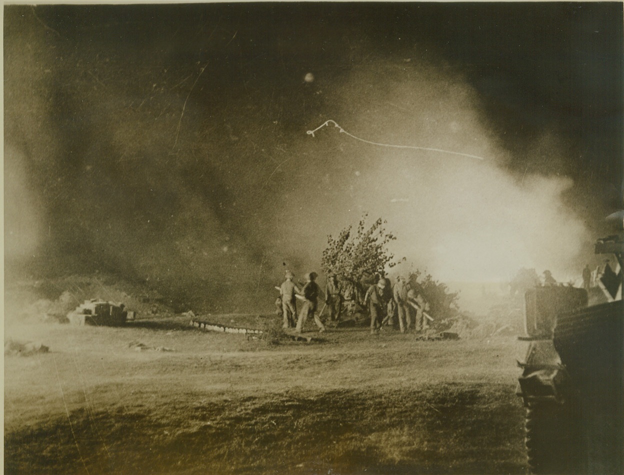 Anti-Aircraft Guns in Action, 10/14/1943. Naples, Italy – The skies around Naples are bright with the light of Allied gunfire as the Allied Fifth Army battles for possession of the important Italian city. Here, anti-aircraft gun crews send their arms into action at night, in the earlier stages of the fight for Naples. Credit: (ACME);