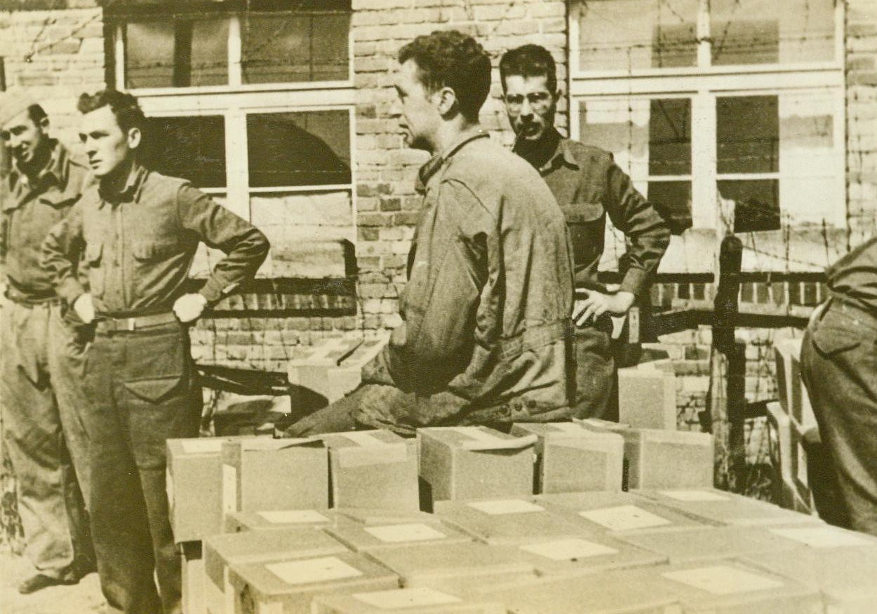 CAPTURED YANKS GET FOOD PARCELS, 10/7/1943. This photo, taken and sent to the U.S. by a Y.M.C.A. War Prisoners Aid delegate who visited the prison camp, shows American soldiers, captured in the fighting in North Africa, as they received 11-pound American Red Cross food packages at Stalag (illegible), a German prison camp southeast of Berlin. The delegate stated that the camp fare, plus the concentrated food in the Red Cross packages, gives the interned Americans a better diet than that of the German civilians.  Credit Line (ACME);