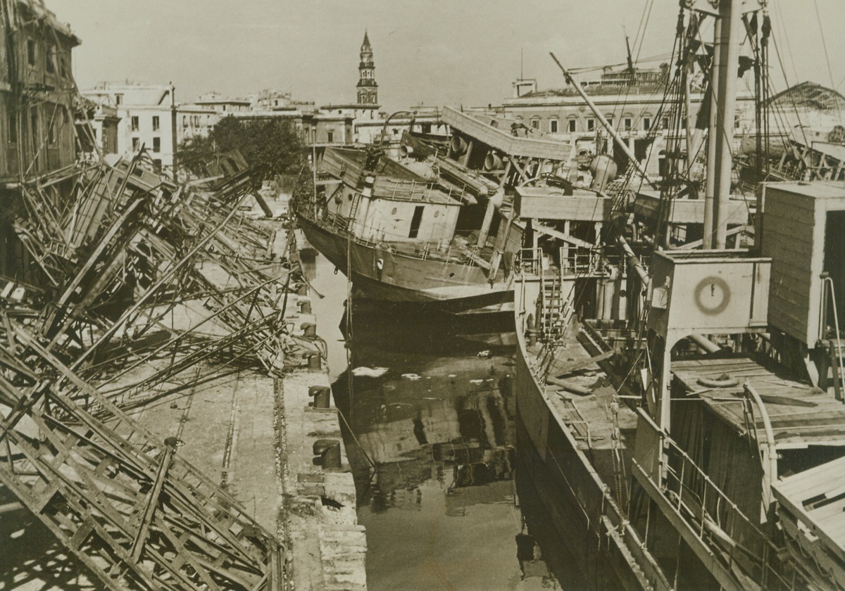 Naples Harbor Strewn with Wreckage, 10/11/1943. ITALY—The harbor of Naples is a mass of twisted steel and wood as the Allies take over the city. Allied bombs and Nazi demolition scrambled the big port, the goal of first drive after the invasion of Italy.  Credit: ACME.;
